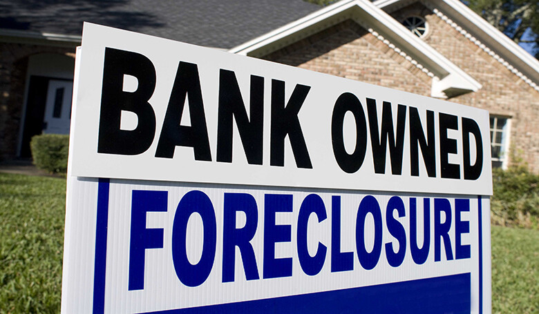 A sign that says bank owned foreclosure.